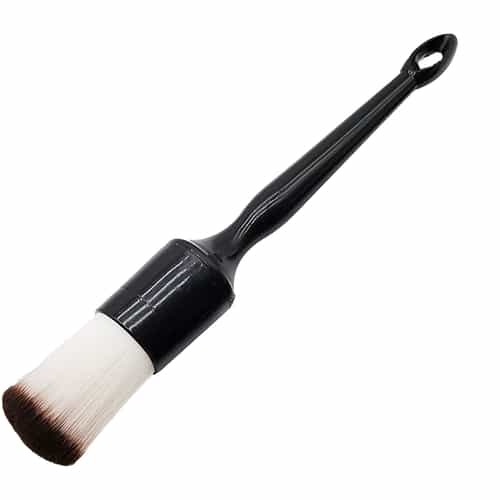 white bristle brush with black handle