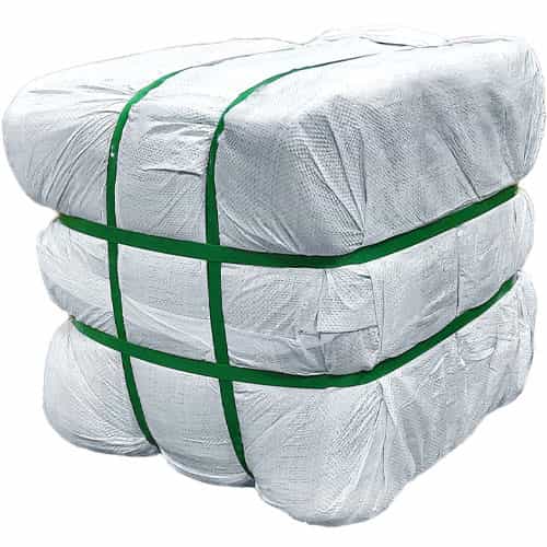 Bale wrapped in white plastic with green straps